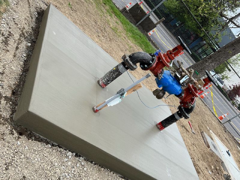 Concrete equipment pad with new water service